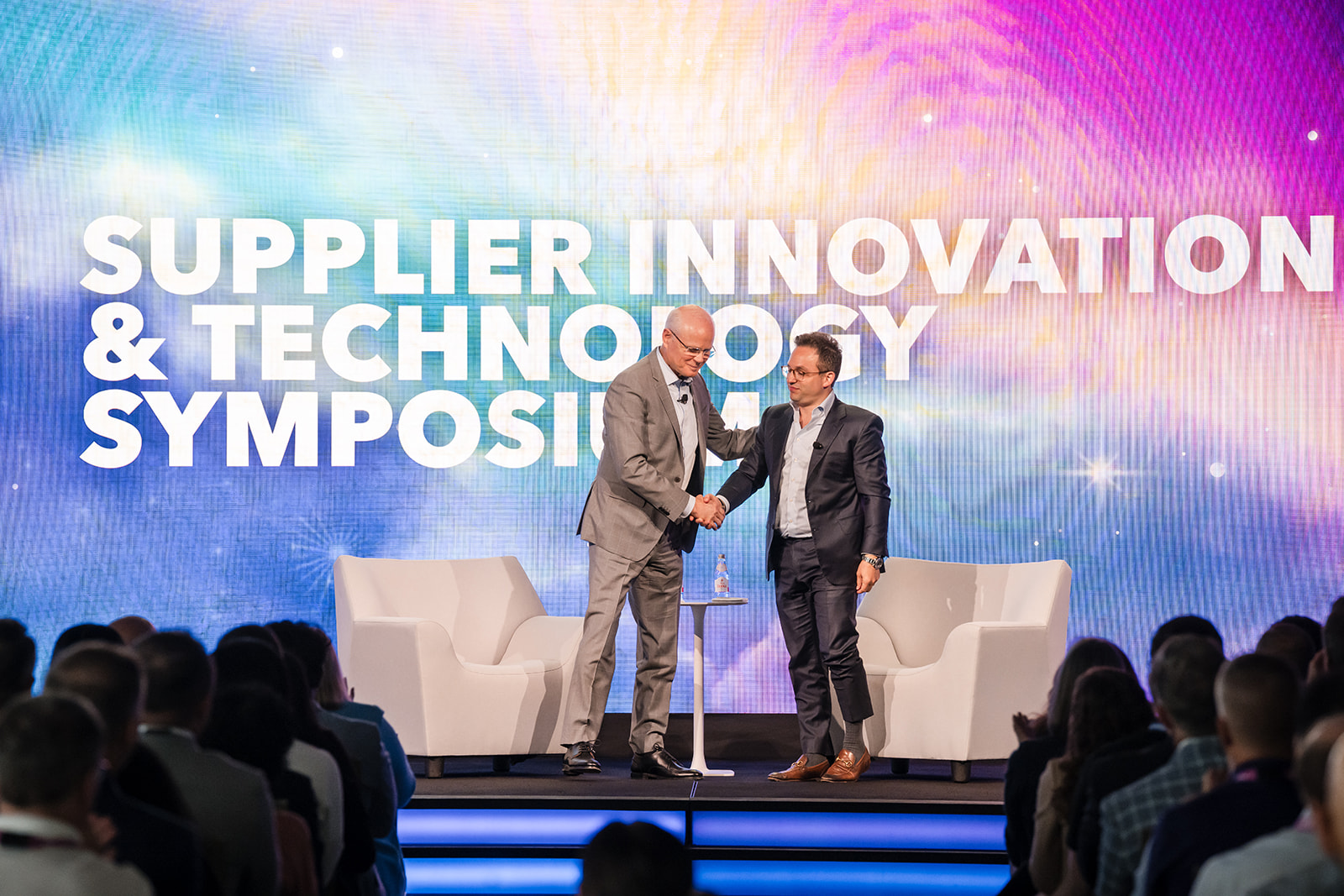 Leidos symposium fireside chat handshake - corporate event