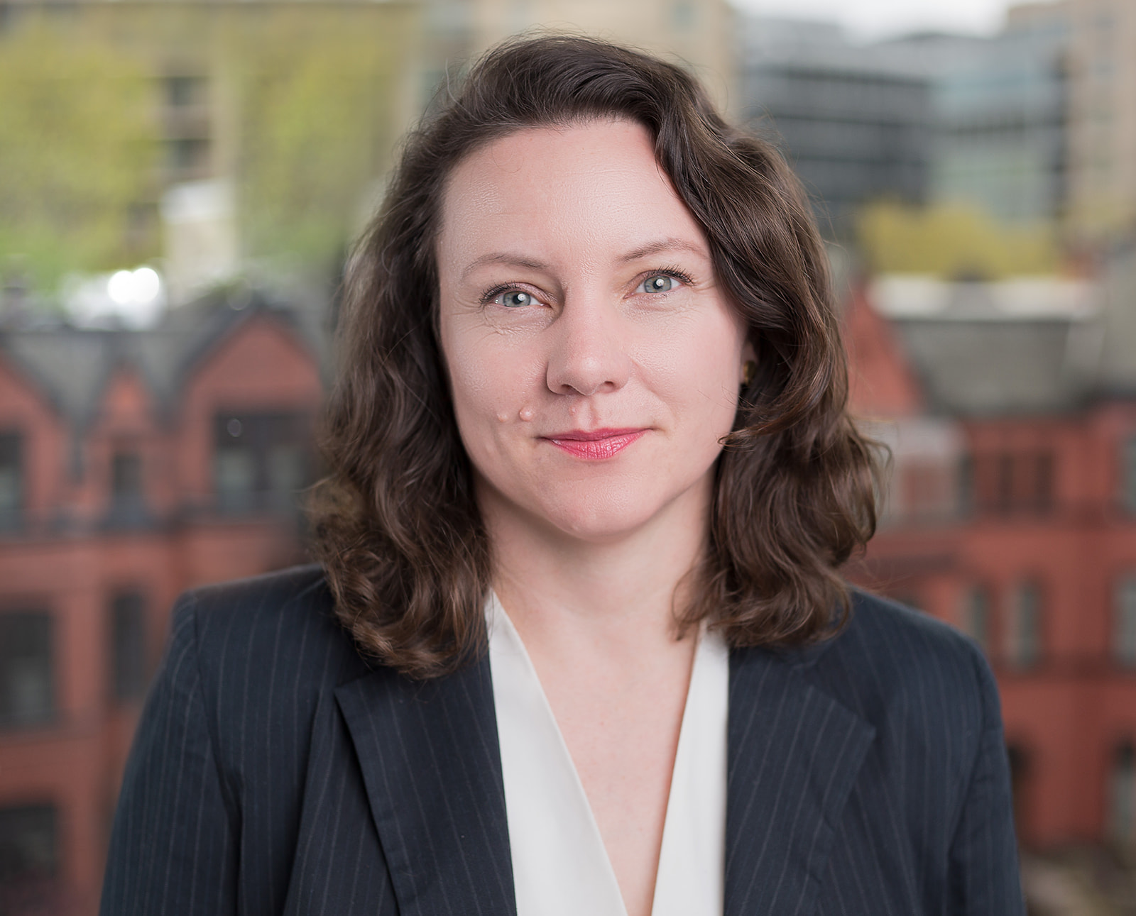 Professional corporate headshot - woman in pinstripe blazer