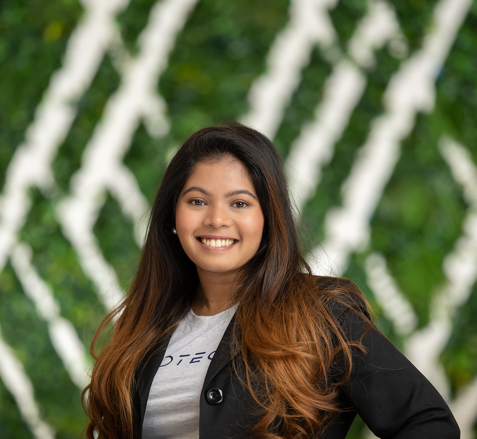 FedTech team portrait - woman smiling green wall backdrop