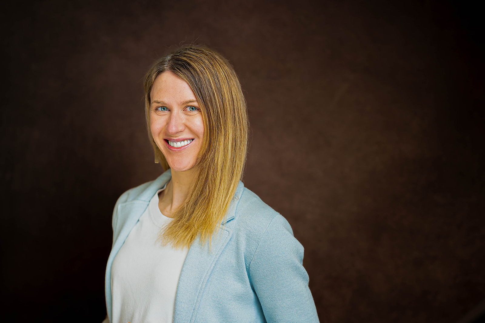 Academic Search executive headshot - woman in light blue blazer
