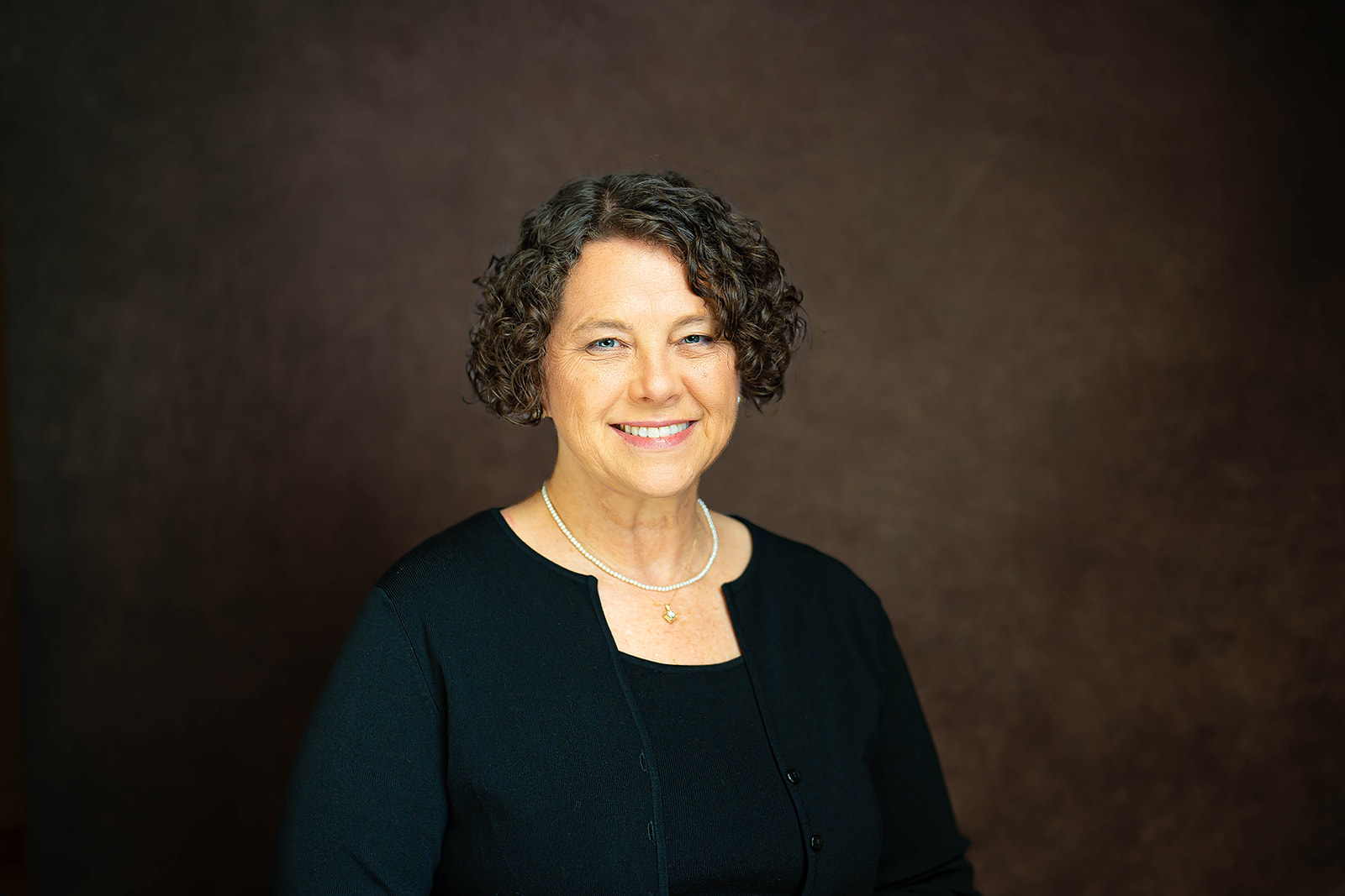 Academic Search executive headshot - woman with pearl necklace